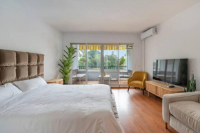 Elegant Studio with Balcony, Pool & Parking